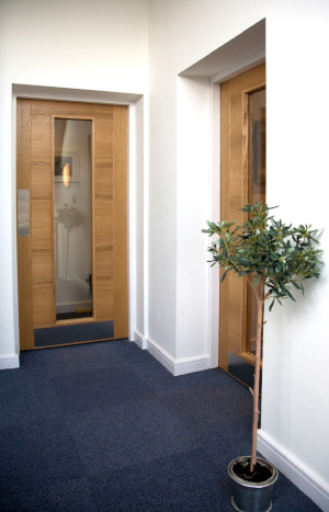 Wooden office doors with a pane of glass going down the length of the door.